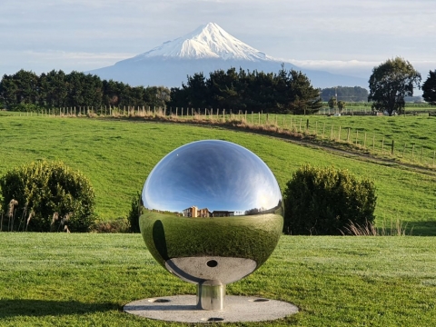 One metre highly polished stainless sphere garden sculpture placed perfectly in line from house to mountain! Mt Taranaki, NZ.